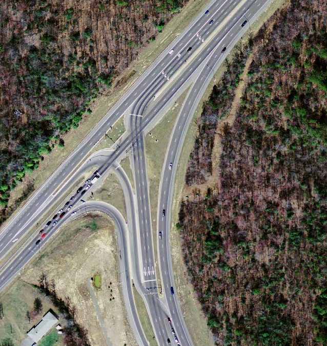 The photo shows a displaced left-turn (DLT) intersection at Indian Head Highway and Berry Road in Accokeek, MD.