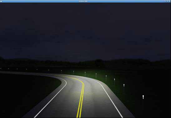 Streaming PMDs condition. The figure depicts a simulator screenshot of the streaming post-mounted delineators (PMDs) curve condition. It shows a left-hand curve on a rural road at night under automobile headlight illumination. The road has a double yellow centerline pavement marking and two white edge line pavement markings, one on each side of the road. There is also a single row of standard PMDs along the right side of the roadway. The first PMD is brighter than the others, indicating the streaming lights effect. All four roadway delineation treatments follow the curve.