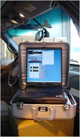 This photo shows a laptop computer docked inside an aluminum square casing suitcase for safe mobility.