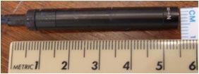 This photo shows a metric ruler next to a National Television System Committee (NTSC) camera.