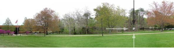 A panoramic photograph is shown. The panorama shows the same area as figure 23 except a 35 mi/h speed limit sign is shown in front of the stand of trees.