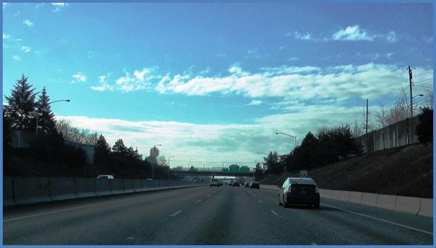 This photo shows an interchange shown to focus groups during the warm-up activity. There is a three-lane highway with cars traveling forward.