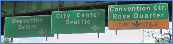 This photo shows guide signs associated with scenario 2 critical point 1. There are three green signs. The sign on the left has a down arrow and is labeled  Beaverton Salem.  The middle sign also has a down arrow and is labeled  City Center Seattle.  The sign on the right is green on the top half and is labeled  Convention Ctr. Rose Quarter.  The bottom half is yellow with a down arrow and is labeled  Exit Only. 