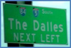 This photo shows a guide sign associated with scenario 3 critical point 2. It is green and labeled  85 5 South The Dalles Next Left. 
