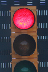 The figure shows a signal head with incandescent bulbs for comparison with the light-emitting diode signal head shown in Figure 2.