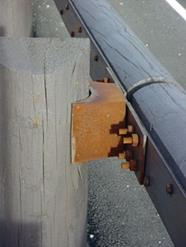 Figure 38. Photo. Barrier type 12—steel-backed timber guardrail.(17)