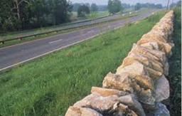 Figure 51. Photo. Barrier end treatment type 3—rock fence.(26)