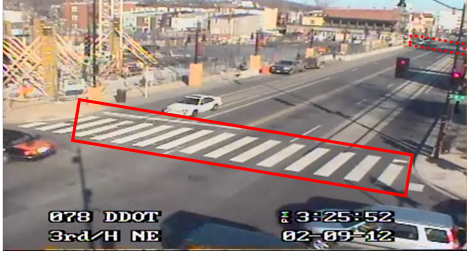Still image captured from the Location 1 camera. The solid red rectangle highlights the intersection of 3rd Street Northeast and H Street Northeast. The dotted red rectangle highlights the intersection of 4th Street Northeast and H Street Northeast in Washington, DC. The photo highlights construction along the north side of the roadway, and some vehicular traffic is in view.