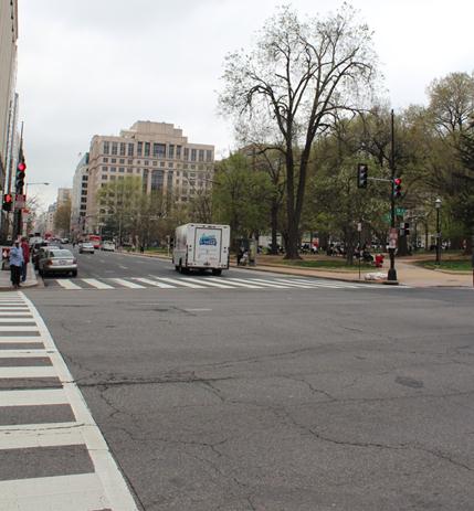 Image of the westernmost crossing of I Street Northwest at 13th Street Northwest. The photo is taken from the southwest corner of the intersection. The image shows the entire crosswalk, taken from the parallel crosswalk.