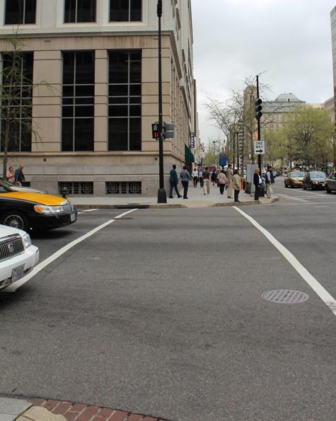 Illustration of what a pedestrian might see as he or she attempts to cross from the south side of H Street Northwest to the north side of the street along 14th Street Northwest. The photograph is taken from the perspective of the pedestrian.