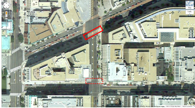 Aerial view of Location 6. The solid red rectangle highlights the intersection of 14th Street Northwest and New York Avenue Northwest. The dotted red rectangle highlights the intersection of 14th Street Northwest and G Street Northwest in Washington, DC. The District of Columbia Department of Transportation camera was positioned facing south and captured pedestrians crossing east/west on 14th Street Northwest between New York Avenue Northwest and G Street Northwest. The aerial view presents a mix of urban commercial property.