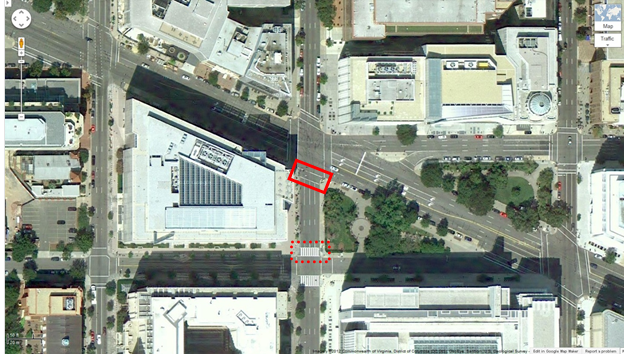 Aerial view of Location 7. The solid red rectangle highlights the intersection of 19th Street Northwest and Pennsylvania Avenue Northwest. The dotted red rectangle highlights the intersection of 19th Street Northwest and H Street Northwest in Washington, DC. The District of Columbia Department of Transportation camera was positioned facing south and captured pedestrians crossing east/west on 19th Street Northwest between Pennsylvania Avenue Northwest and H Street Northwest. The aerial view presents a mix of urban commercial property with a small park area to the east of the relevant intersection.