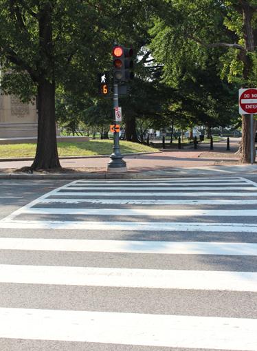 Illustration of what a pedestrian might see as he or she attempts to cross from the north side of H Street Northwest to the south side of the street along Connecticut Avenue Northwest. The photo is taken from the pedestrian perspective. No other pedestrian or vehicle traffic can be seen.
