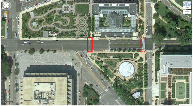 Aerial view of Location 14. The solid red rectangle highlights the intersection of Independence Avenue Southwest and Washington Avenue Southwest. The dotted red rectangle highlights the intersection of Independence and 1st Street in Washington, DC. The District of Columbia Department of Transportation camera was positioned facing east and captured pedestrians crossing north/south on Independence Avenue Southwest between Washington Avenue Southwest and 1st Street Southwest. One large office building can be seen. The remainder of the area is green space or portions of the Botanic Garden.