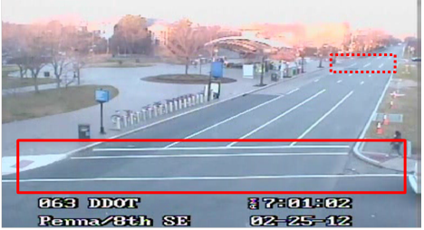 Still image captured from the Location 15 camera. The solid red rectangle highlights the intersection of Pennsylvania Avenue Southeast and 8th Street Southwest. The dotted red rectangle highlights the intersection of Pennsylvania Avenue and 7th Street Southeast in Washington, DC. The Metro station can be seen to the left of the main roadway, and a pedestrian is waiting to cross the street at the marked crosswalk.