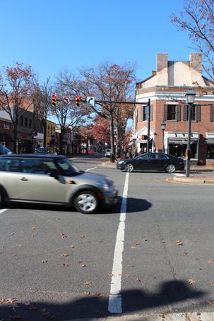 Illustration of what a pedestrian might see as he or she attempts to cross from the east side to the west side of North Washington Street along King Street in Alexandria, VA. The photograph is taken from the pedestrian perspective. Crossing vehicle traffic has the right of way, and vehicles can be seen crossing through the crosswalk.