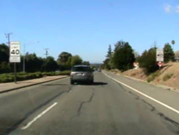 Figure 14. Photo. Verifying data with video. This figure is a video still image of the location noted in figure 13. The image shows the cross-section of the roadway, the presence of 40-mile per hour/hr posted speed limit signs, and the condition of the pavement markings.