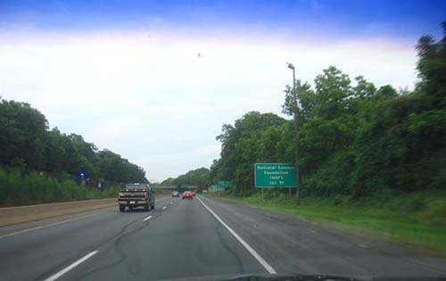Figure 2. Photo. A series of four consecutive supplemental guide signs at a Virginia interchange