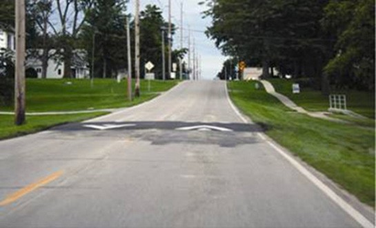 Figure 141. Photo. Speed table. This figure shows an example of a speed table. Speed tables are midblock traffic calming devices that raise the entire wheelbase of a vehicle to reduce its traffic speed. Speed tables are longer than speed humps and flat-topped, with a typical height of 3 to 3.5 inches and a length of 22 ft.