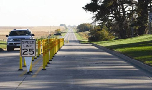 Figure 144. Photo. Tubular channelizers. This figure shows an example of a tubular channelizer. Tubular channelizers are 3-ft tall yellow markers placed on either side of the centerline to create an island. These can reduce lane width.