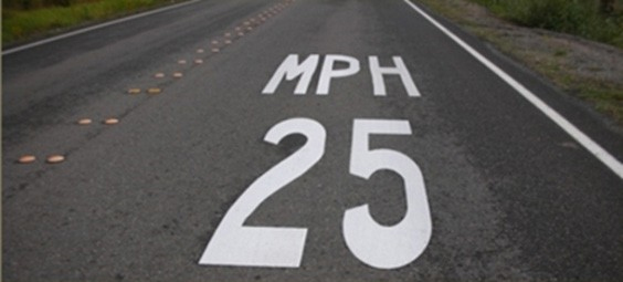 Figure 154. Photo. Speed limit pavement legend. This figure shows an example of a speed limit pavement legend. A speed limit pavement legend places pavement markings at regularly spaced intervals to remind drivers of the speed limit.