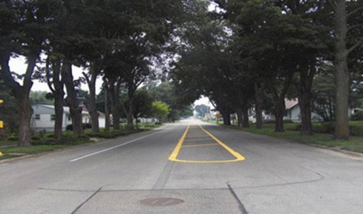 Figure160. Photo. Add centerline and edge line. This figure shows an example of zigzag centerline and edgeline markings. Installation of median and shoulder pavement markings reduces lane widths.