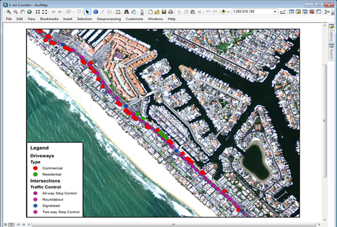 Figure 3. Layer map. Example of point objects for a 1-mi corridor. This map shows an ArcGISâ„¢ layer map for a 1-mi corridor with an aerial photo as the background. Several different colored dots are placed along the corridor to represent the locations of point objects. A legend on the bottom left indicates that the red and green dots represent commercial and residential driveways, respectively. The legend also shows that the blue dots represent signalized intersections, and the pink dots denote all-way stop control intersections, two-way stop control intersections, and roundabouts. 