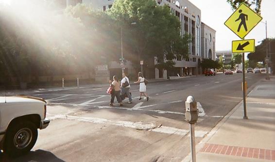 Figure 11. Photo. Unsignalized pedestrian crosswalk in Stockton, CA. Same crosswalk as figure 9, but taken when three pedestrians were crossing in the crosswalk.