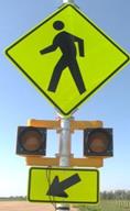 Figure 28. Photo. C-B8, lap B study assembly. A Pedestrian Crossing sign assembly with a set of 8-inch circular beacons between the W11-2 sign and the W16-7P arrow plaque.