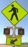 Figure 28. Photo. C-B8, lap B study assembly. A Pedestrian Crossing sign assembly with a set of 8-inch circular beacons between the W11-2 sign and the W16-7P arrow plaque. Figure 28. Photo. C-B8, lap B study assembly. A Pedestrian Crossing sign assembly with a set of 8-inch circular beacons between the W11-2 sign and the W16-7P arrow plaque.