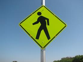 Figure 35. Photo. LED, lap A study assembly. A Pedestrian Crossing sign with yellow light-emitting diodes embedded in eight places (each corner and each side’s midpoint) on the black border of the sign. Figure 35. Photo. LED, lap A study assembly. A Pedestrian Crossing sign with yellow light-emitting diodes embedded in eight places (each corner and each side’s midpoint) on the black border of the sign.