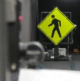 Figure 44. Photo. LED-embedded sign mounted on goniometer. A Pedestrian Crossing sign with embedded light-emitting diodes is shown mounted on equipment in a laboratory.
