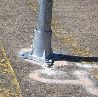 Figure 53. Photo. Base for signs without beacons/LEDs. A close-up of the base used to support the signs that did not have beacons or light-emitting diodes. The base is about 6 inches wide where it is bolted onto the pavement. Figure 53. Photo. Base for signs without beacons/LEDs. A close-up of the base used to support the signs that did not have beacons or light-emitting diodes. The base is about 6 inches wide where it is bolted onto the pavement.