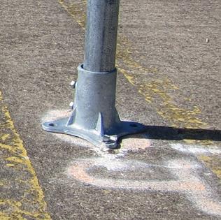 Figure 53. Photo. Base for signs without beacons/LEDs. A close-up of the base used to support the signs that did not have beacons or light-emitting diodes. The base is about 6 inches wide where it is bolted onto the pavement.