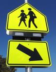 Figure 76. Photo. Rectangular beacons used at CS-01. A school Pedestrian Crossing sign assembly with a set of rectangular beacons between the S1-1 sign and the W16-7P arrow plaque.