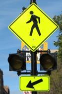 Figure 80. Photo. Circular beacons used at MK-04. A Pedestrian Crossing sign assembly with a set of circular beacons between the W11-2 sign and the W16-7P arrow plaque.