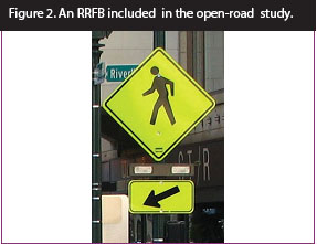 Figure 2. Photo. An RRFB included in open-road study. This photo features a pedestrian crossing sign assembly with a set of rectangular beacons between the W11-2 sign and the W16-7P arrow plaque. Figure 2. Photo. An RRFB included in open-road study. This photo features a pedestrian crossing sign assembly with a set of rectangular beacons between the W11-2 sign and the W16-7P arrow plaque.