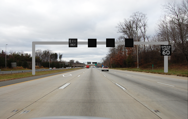 Figure 28. Photo. Picture for the resting condition for Washington-based signs. This figure shows a four-lane highway with active traffic management signs over each lane and a changeable message sign (CMS) on the gantry to the right. The left lane shows a high-occupancy vehicle lane restriction sign, which is a diamond with the text "2+ ONLY". The signs above the other three lanes are blank. The CMS on the gantry on the right shows "SPEED LIMIT 60."