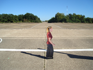 Figure 11. Photo. Training example with pedestrian facing right. This photo shows the photograph cutout of a pedestrian facing right in the crosswalk spanning a two-lane road. The instructions below the photo state, "When the pedestrian in the crosswalk is moving to the right (as shown) please press (5) (do so now)."