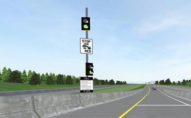This figure shows a screen capture of an entrance ramp meter. An on-ramp is shown, and it slopes down to a single travel lane. There is a concrete barrier on either side of the ramp. Atop the left-side barrier is a pair of two-lens signals. Both signals are showing the lower (green) lens illuminated. The signals are mounted one above the other. Between the two signals is a “Stop Here on Red” regulatory sign (R10-6a).