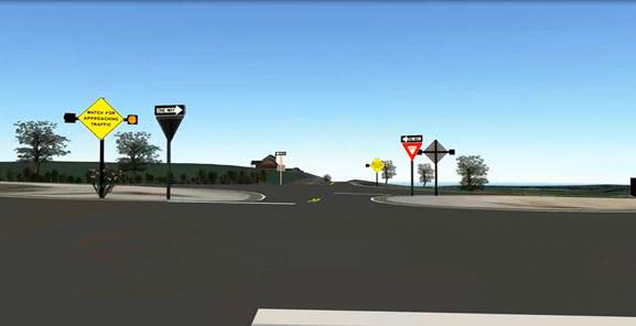 Figure 8. Screenshot. ICWS at stop-controlled approach to four-lane divided highway. This screenshot features a minor road intersecting with a four-lane divided highway and is situated from the perspective of the minor road. On the left side of the dividing media, there is a one-way sign (pointing right) and an intersection conflict warning system (ICWS) with a yellow diamond sign that reads, “WATCH FOR APPROACHING TRAFFIC,” and it has beacons on both sides (one of which is lit). On the right side of the dividing media, there is a triangular yield sign and a one-way sign pointing left. On the right corner of the far side of the intersection, there is an ICWS with a yellow diamond sign that reads “WATCH FOR APPROACHING TRAFFIC,” and it has beacons on both sides (one of which is lit).