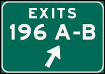 Figure 15-B. Photo. Exit gore sign with legend grouping applied. This sign includes the directional arrow placed below the exit number and letters.
