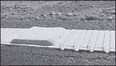 This figure is a close-up image of a section of pavement marking in a pattern of several small raised ridges, followed by one higher, longer ridge.