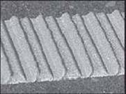 This figure is a close-up image of a section of pavement marking in a pattern of indentations and ridges that are equally sized and spaced.