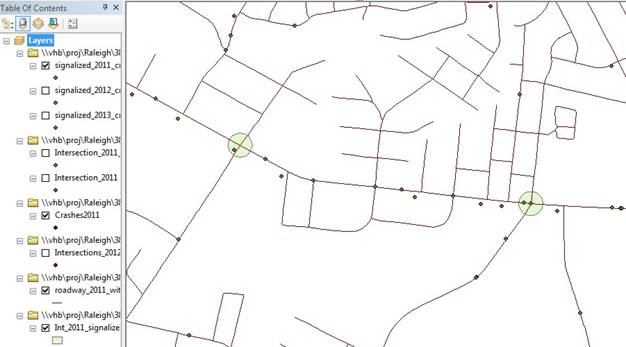 The screenshot shows a GIS map of the road network with dots placed where crashes occurred. Two intersections have shaded circles around them. One intersection circled has one crash within the circle, and the other has two crashes.
