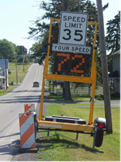 This is a photo of a speed-activated speed-limit-reminder sign. It is activated by approaching vehicles and displays their current speed. The sign shows the legal speed limit above, in this case, 35, and below is a digital screen that shows drivers their current speed, in this case, 72.