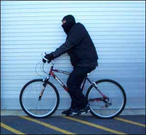 Photo. Cyclist in black clothing. Click here for more detail.