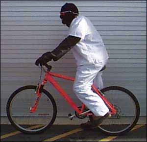 Photo. Cyclist in white clothing. Click here for more detail.