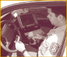 Law enforcement officer scans license with bar code reader to capture driver