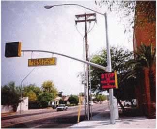 Figure 29.	The combination of over-head and street-side pedestrian crossing signs on this urban road had mixed results in its impact on pedestrian crashes
